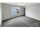 Bedroom with gray carpet, two windows and a closet door at 722 Ladino Ln, Clover, SC 29710