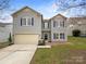 Charming two-story home with gray siding, blue shutters, and a large garage at 722 Ladino Ln, Clover, SC 29710