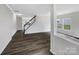 Open-concept living room with dark wood flooring and a staircase leading to the upper level at 722 Ladino Ln, Clover, SC 29710