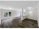 Spacious living room with large windows, neutral walls, and elegant wood-look flooring at 722 Ladino Ln, Clover, SC 29710
