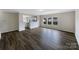Spacious living room with hardwood floors and a view of the backyard through large windows at 722 Ladino Ln, Clover, SC 29710