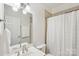 Clean, well-lit bathroom with a large mirror, vanity, and shower with neutral-toned tile at 727 Mayfield Ct, Fort Mill, SC 29715