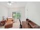 Cozy bedroom space with chair, desk, and natural light from a large window overlooking a green outdoor area at 727 Mayfield Ct, Fort Mill, SC 29715
