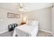 Bright bedroom featuring a queen bed, soft carpeting, and outdoor views from a window at 727 Mayfield Ct, Fort Mill, SC 29715