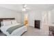 Bright bedroom with soft carpeting, a bed, and two entryways, with a glimpse into the en suite bathroom at 727 Mayfield Ct, Fort Mill, SC 29715