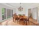 Bright dining room featuring hardwood floors, chandelier and a large window offering an abundance of natural light at 727 Mayfield Ct, Fort Mill, SC 29715
