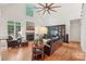 Inviting living room with vaulted ceilings, hardwood floors, a fireplace, and comfortable leather furniture at 727 Mayfield Ct, Fort Mill, SC 29715