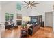 Cozy living room with a fireplace, hardwood floors, comfortable leather furniture, and a ceiling fan at 727 Mayfield Ct, Fort Mill, SC 29715