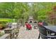 Relaxing outdoor patio with an outdoor fireplace, built-in grill, and lush landscaping for entertaining at 727 Mayfield Ct, Fort Mill, SC 29715