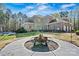 A backyard offers an outdoor fire pit and a tranquil setting with mature trees at 7509 Webbs Chapel Cove Ct, Denver, NC 28037