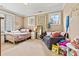 Cozy bedroom with a full bed, sitting area, and sun-filled windows at 7509 Webbs Chapel Cove Ct, Denver, NC 28037