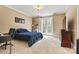Inviting bedroom with desk, ample lighting, and doors leading to outdoor space at 7509 Webbs Chapel Cove Ct, Denver, NC 28037