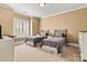 Comfortable bedroom with neutral carpet, twin beds, and natural lighting at 7509 Webbs Chapel Cove Ct, Denver, NC 28037
