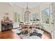 Bright dining area with multiple windows, hardwood floors, and stylish decor at 7509 Webbs Chapel Cove Ct, Denver, NC 28037