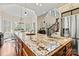 Close-up of a kitchen island with granite countertop, ample storage, and adjacent breakfast area at 7509 Webbs Chapel Cove Ct, Denver, NC 28037