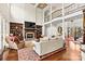 Spacious living room with a fireplace, built-in bookshelves, and an open layout at 7509 Webbs Chapel Cove Ct, Denver, NC 28037