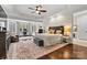 Spacious main bedroom suite with tray ceilings, sitting area, and large windows at 7509 Webbs Chapel Cove Ct, Denver, NC 28037