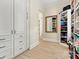 Spacious walk-in closet with custom built-ins, ample shelving, and stylish wood-look flooring at 7509 Webbs Chapel Cove Ct, Denver, NC 28037