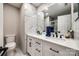 This renovated bathroom boasts double sink, a modern vanity, and beautiful marble look tile at 810 Rock Lake Gln, Fort Mill, SC 29715