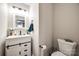Half bathroom featuring a stylish vanity with a white countertop and a decorative sliding door at 810 Rock Lake Gln, Fort Mill, SC 29715