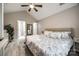 This primary bedroom features vaulted ceilings, a ceiling fan and a private ensuite bathroom at 810 Rock Lake Gln, Fort Mill, SC 29715
