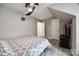 Comfortable bedroom featuring modern flooring, ceiling fan, and a television set up for entertainment at 810 Rock Lake Gln, Fort Mill, SC 29715