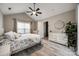 This spacious bedroom features wood-look floors, a ceiling fan, and a walk in closet at 810 Rock Lake Gln, Fort Mill, SC 29715