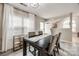 Bright dining space features a modern table set, hardwood floors, and large windows for natural light at 810 Rock Lake Gln, Fort Mill, SC 29715