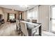 Open dining area showcases a dark wood table set, flowing seamlessly into the living room with ample natural light at 810 Rock Lake Gln, Fort Mill, SC 29715