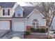 Charming townhome with light gray siding, brick accents, well-manicured landscaping, and an attached one-car garage at 810 Rock Lake Gln, Fort Mill, SC 29715