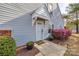 Inviting front entrance with a white door, stylish awning, and vibrant landscaping with blooming azalea bushes at 810 Rock Lake Gln, Fort Mill, SC 29715