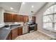 Modern kitchen features stainless steel appliances, dark wood cabinets, and a large window for natural light at 810 Rock Lake Gln, Fort Mill, SC 29715