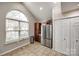 Bright kitchen with stainless steel refrigerator, tile flooring, ample counter space, and large window at 810 Rock Lake Gln, Fort Mill, SC 29715