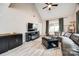 Spacious living room features vaulted ceiling, ceiling fan, fireplace, and a large sectional sofa at 810 Rock Lake Gln, Fort Mill, SC 29715