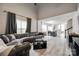 Open concept living room and dining area featuring stylish gray flooring and a large sectional sofa at 810 Rock Lake Gln, Fort Mill, SC 29715
