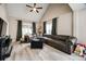 Inviting living room with a large sectional sofa, hardwood floors, vaulted ceiling, and ample natural light at 810 Rock Lake Gln, Fort Mill, SC 29715