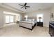 Spacious main bedroom featuring tray ceilings and a seating area at 8457 Loxton Cir, Charlotte, NC 28214