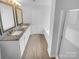 Bathroom showcasing dual sinks with granite countertops, framed mirrors, and a separate tub at 9037 Pembroke Ct, Fort Mill, SC 29707