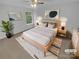 A staged bedroom featuring neutral tones, a ceiling fan, a window with a natural outdoor view and modern decorations at 9037 Pembroke Ct, Fort Mill, SC 29707
