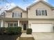 Inviting two-story home with a manicured lawn and a two-car garage at 9037 Pembroke Ct, Fort Mill, SC 29707
