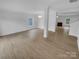 Bright living room showcasing an open floor plan, modern lighting, and hardwood floors at 9037 Pembroke Ct, Fort Mill, SC 29707