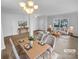 Bright living room and dining area with a modern chandelier and views of the front yard at 9037 Pembroke Ct, Fort Mill, SC 29707
