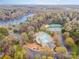 Aerial view featuring a community pool, tennis courts, lake, and manicured landscaping at 9238 Heritage Woods Pl, Charlotte, NC 28269