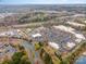 Aerial view of a commercial district showing shopping, restaurants, and a lake at 9238 Heritage Woods Pl, Charlotte, NC 28269