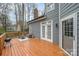 Spacious back deck featuring outdoor furniture and a grill, accessible through French doors at 9238 Heritage Woods Pl, Charlotte, NC 28269