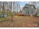 Large backyard featuring a spacious deck, a storage shed and mature trees at 9238 Heritage Woods Pl, Charlotte, NC 28269