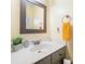 Well-lit bathroom featuring a vanity with sink, framed mirror, and a fresh aesthetic at 9238 Heritage Woods Pl, Charlotte, NC 28269