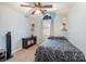 Cozy bedroom with a ceiling fan, large window, neutral carpet, and light blue walls at 9238 Heritage Woods Pl, Charlotte, NC 28269