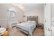 Bright bedroom featuring vaulted ceiling, large window, and carpet flooring at 9238 Heritage Woods Pl, Charlotte, NC 28269