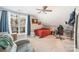 Comfortable bedroom with a large window, neutral carpet, and an accent brick wall at 9238 Heritage Woods Pl, Charlotte, NC 28269